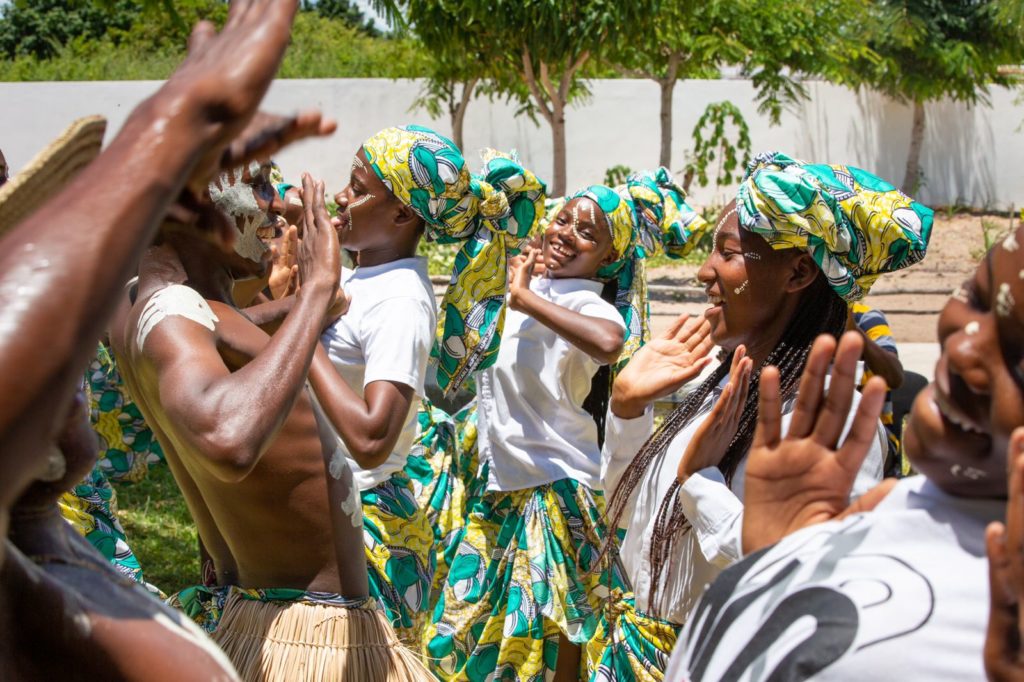 Women and children dancing together at a Goodwill celebration
