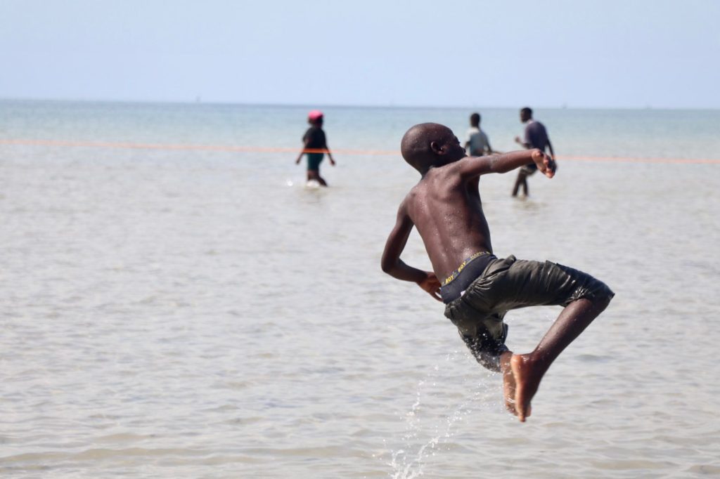A boy leaping into the sea in Vilanculos