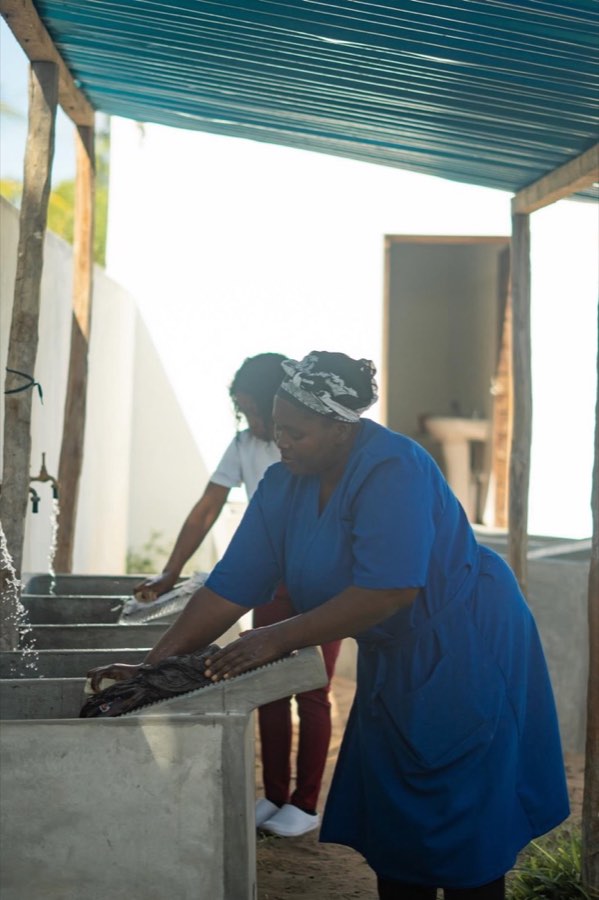 A member of the Goodwill team at the outdoor sinks