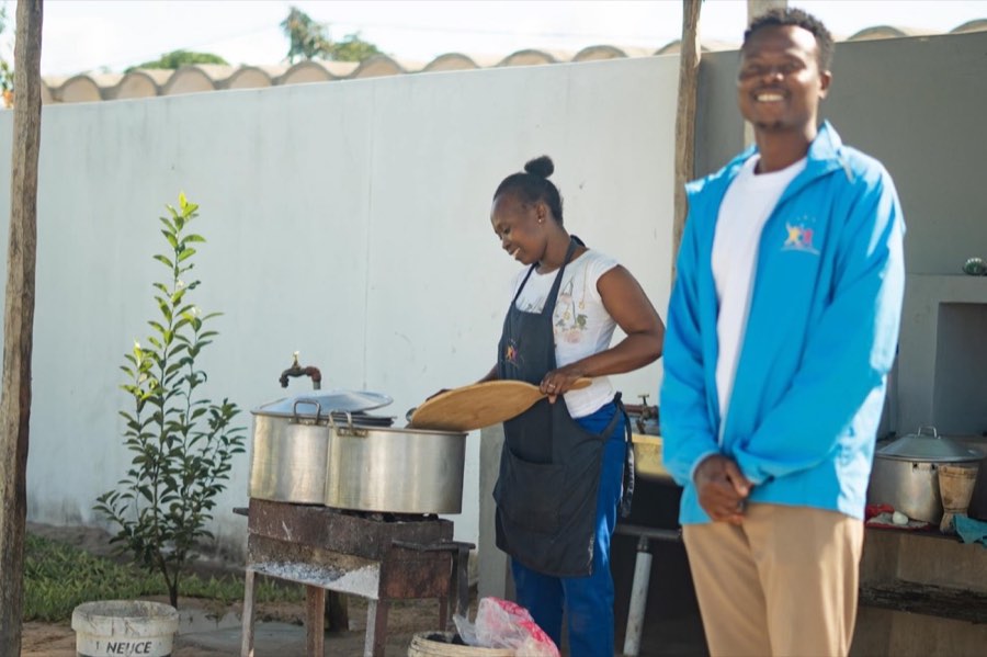 A Goodwill cook and a team member at the outside kitchen