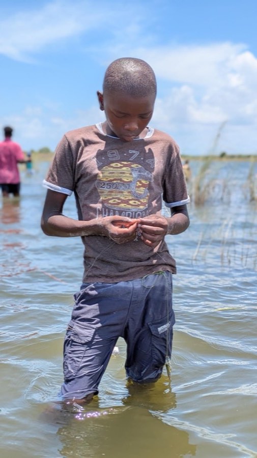 A child holding the day’s catch at the lake