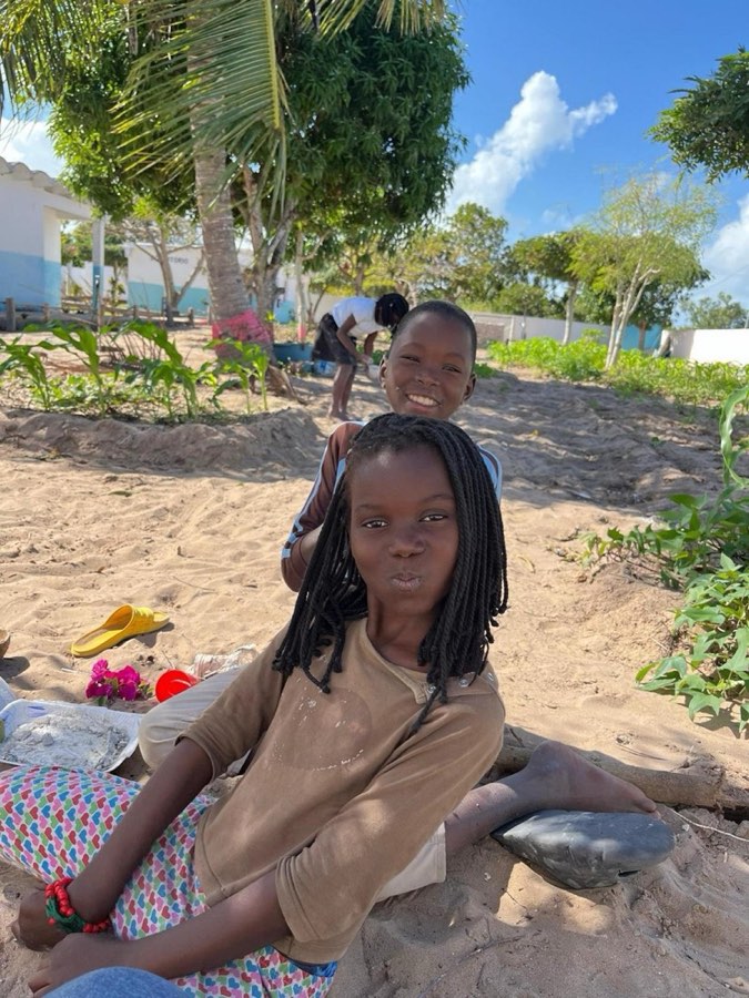 A girl sitting on the sand in Vilanculos