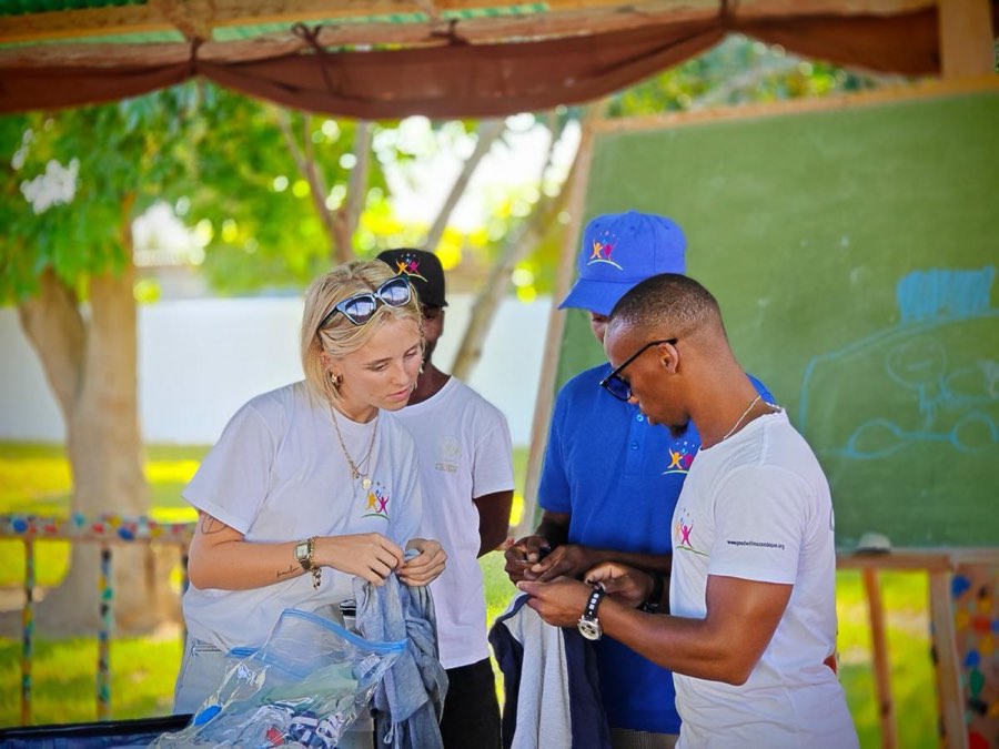 A volunteer working one to one with a child at a table